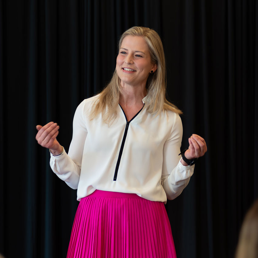A photo of Marie speaking to an audience